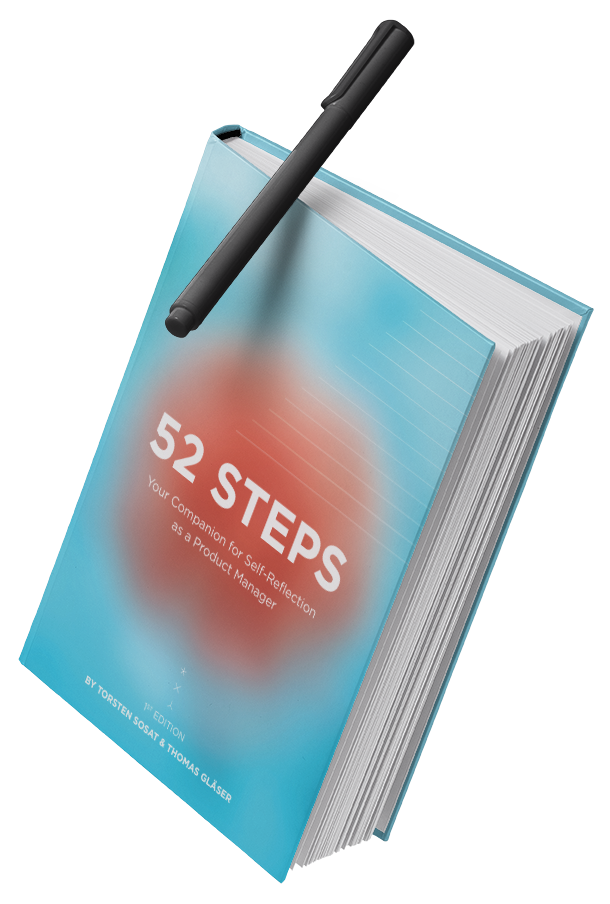 Book titled '52 Steps: Your Companion for Self-Reflection as a Product Manager' with a black pen resting on top.