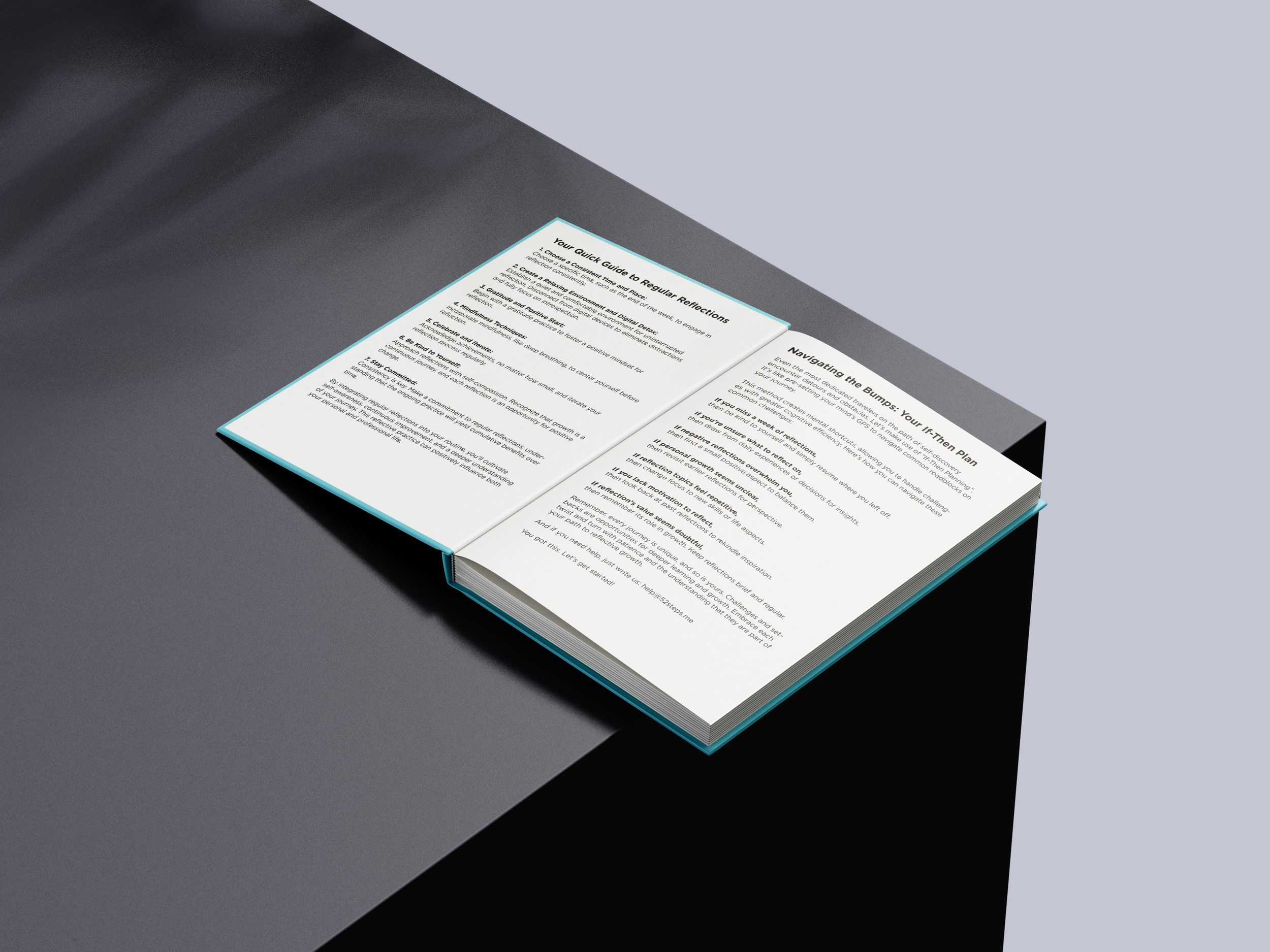 Open book resting on a black and grey surface.